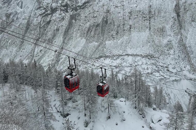 Red cables cars in the snow in Chamonix
